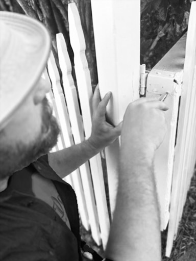 Resetting a gate hinge on a picket fence