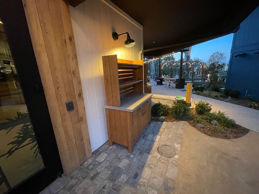 Outdoor service hutch at dusk, lamp lit