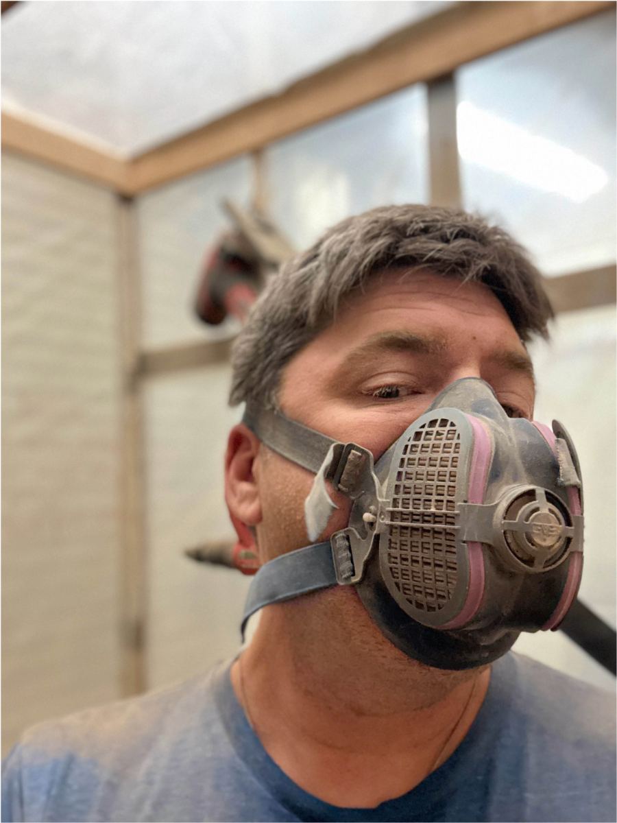 Respirator on, inside a dust-contained work tent